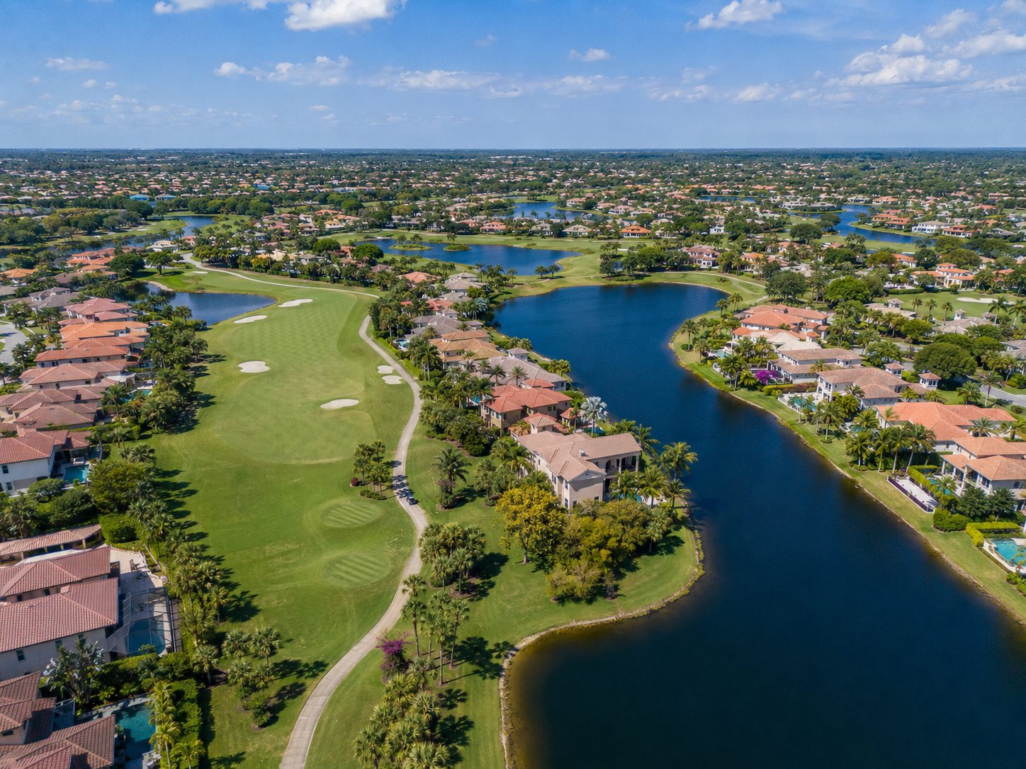 Aerial view of Fairway Estates — homes winding along championship fairways and lakes